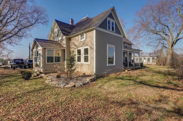 view of side of home with a lawn