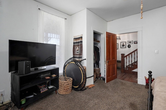 interior space with dark colored carpet and a closet