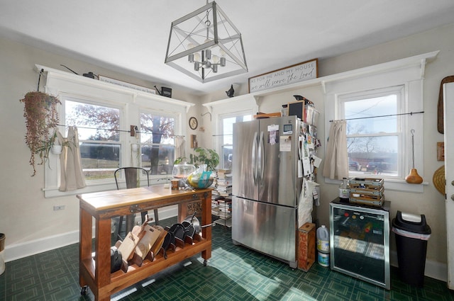 kitchen with stainless steel fridge, beverage cooler, and a chandelier