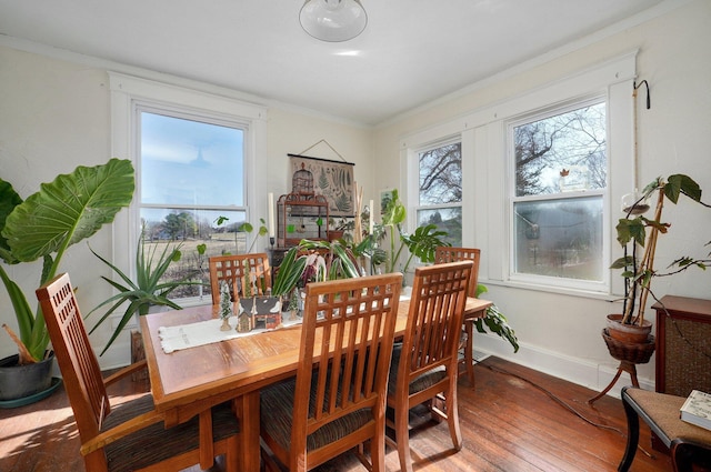 dining room featuring hardwood / wood-style flooring and ornamental molding