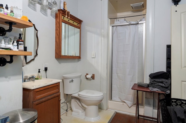 bathroom featuring vanity, toilet, and curtained shower