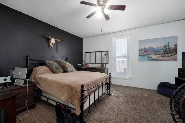 bedroom with ceiling fan and dark carpet