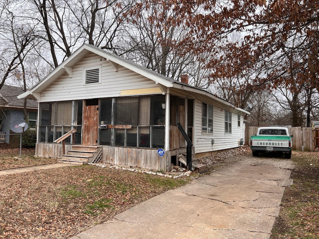 view of front of house with a sunroom