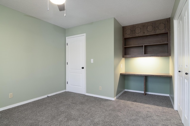 1012 W Monarch Dr, Nixa, MO 65714 - unfurnished bedroom featuring carpet floors, a textured ceiling, an office area, and a ceiling fan