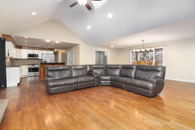 1012 W Monarch Dr, Nixa, MO 65714 - living room with a chandelier, a ceiling fan, hardwood / wood-style floors, recessed lighting, and high vaulted ceiling