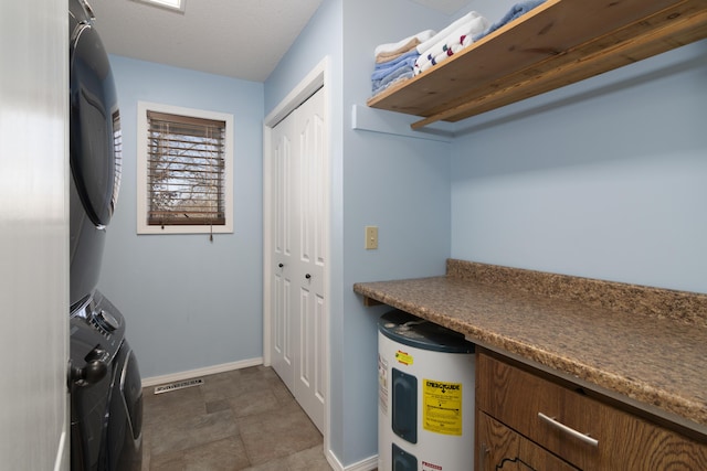 1012 W Monarch Dr, Nixa, MO 65714 - washroom with water heater and stacked washer / dryer