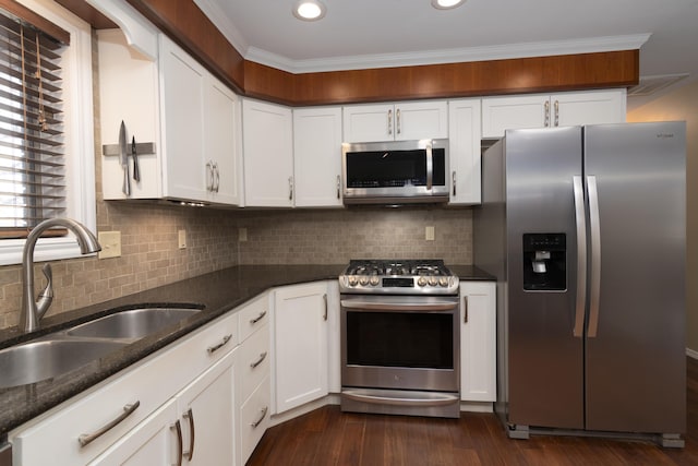 1012 W Monarch Dr, Nixa, MO 65714 - kitchen featuring appliances with stainless steel finishes, white cabinets, dark stone countertops, dark wood-style floors, and recessed lighting
