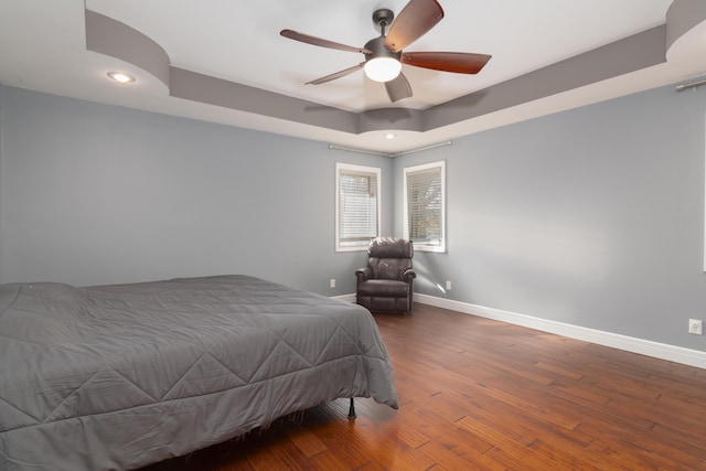 1012 W Monarch Dr, Nixa, MO 65714 - bedroom featuring a tray ceiling, wood-type flooring, recessed lighting, and ceiling fan