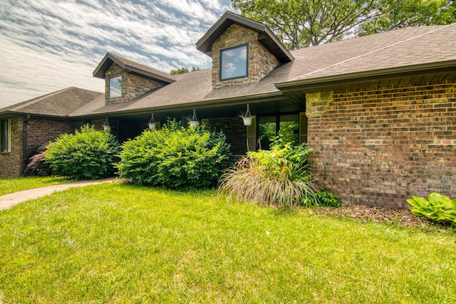 1012 W Monarch Dr, Nixa, MO 65714 - view of home's exterior featuring a yard, brick siding, and a shingled roof