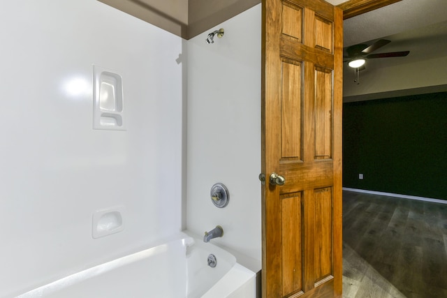 bathroom featuring shower / tub combination, ceiling fan, and wood-type flooring