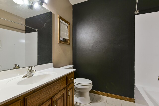 bathroom with tile patterned flooring, vanity, and toilet