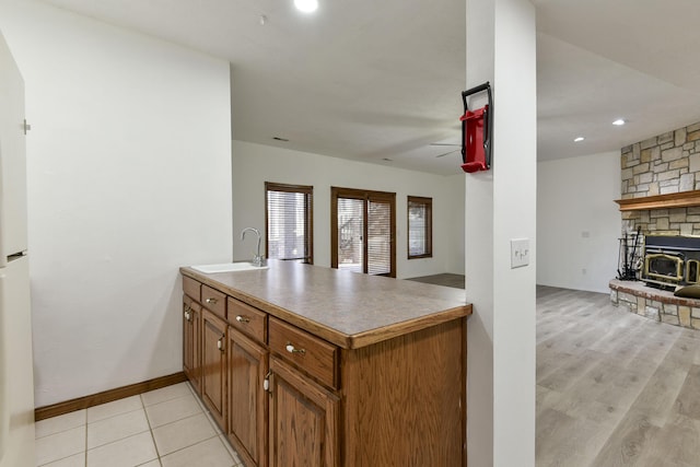 kitchen featuring kitchen peninsula, sink, and light hardwood / wood-style flooring