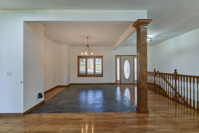 foyer entrance featuring a notable chandelier