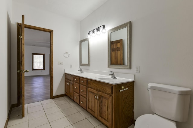 bathroom featuring tile patterned flooring, vanity, and toilet