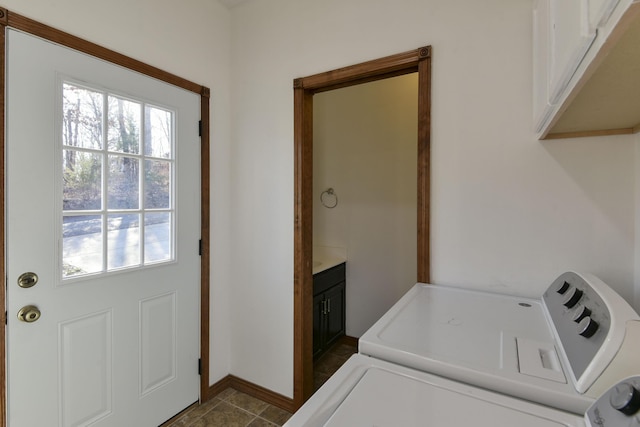 laundry room with washer and clothes dryer and cabinets