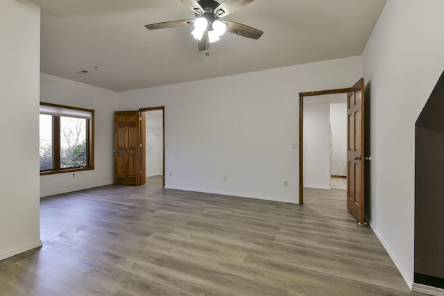 spare room featuring ceiling fan and light wood-type flooring