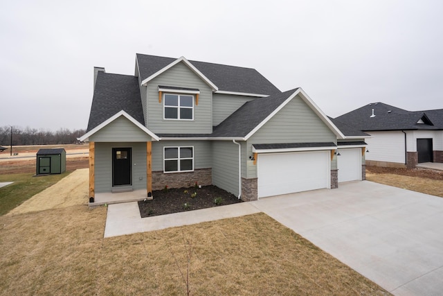 craftsman-style home with a front yard and a garage