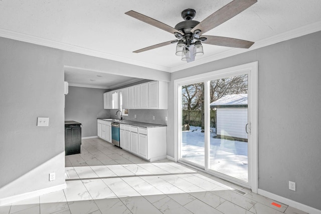 kitchen with dishwasher, tasteful backsplash, white cabinets, ceiling fan, and sink