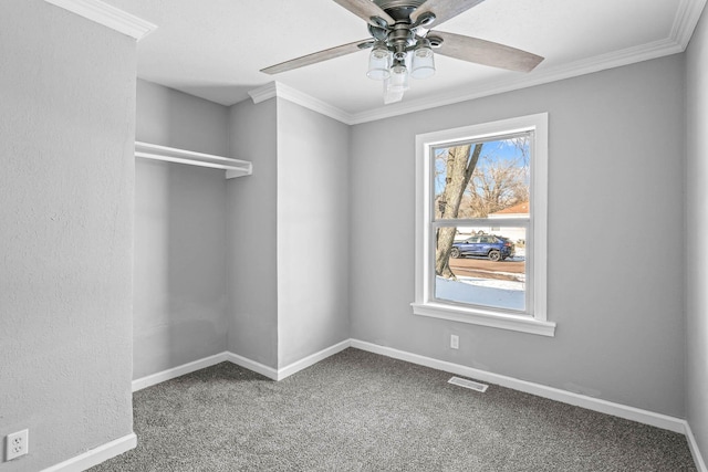 unfurnished room featuring ceiling fan, crown molding, and carpet