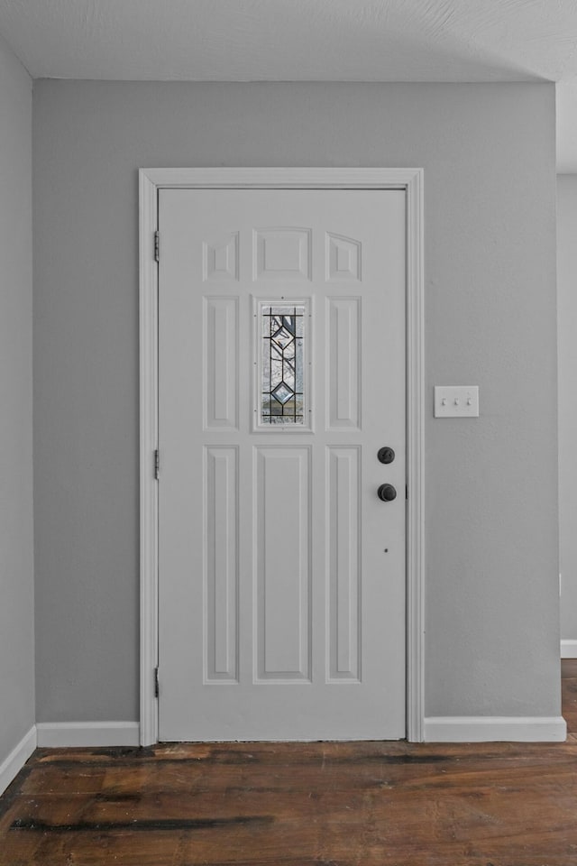 foyer entrance with dark hardwood / wood-style floors