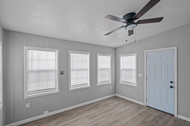 spare room with ceiling fan and light hardwood / wood-style flooring