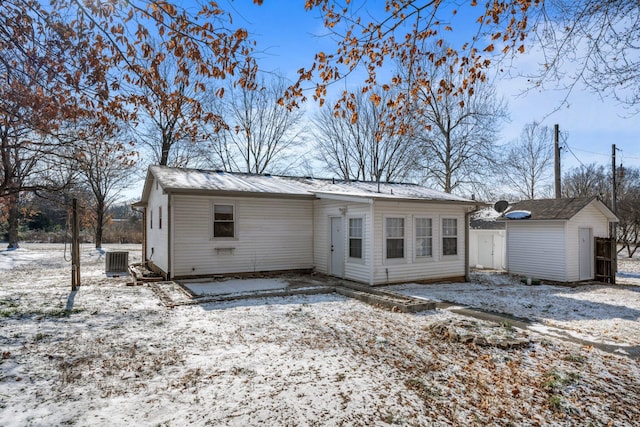 snow covered house with central AC unit