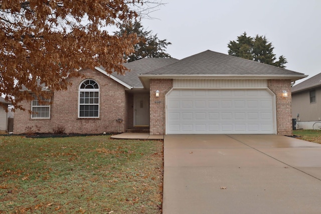 ranch-style house with a front yard and a garage