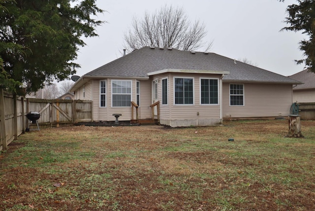 rear view of house with a yard