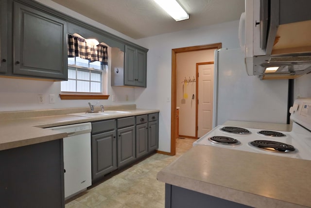 kitchen with gray cabinets, white appliances, and sink