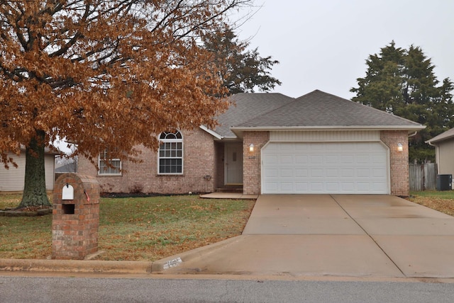 view of front facade featuring central AC unit, a garage, and a front lawn