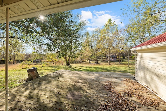 wooden deck with a lawn