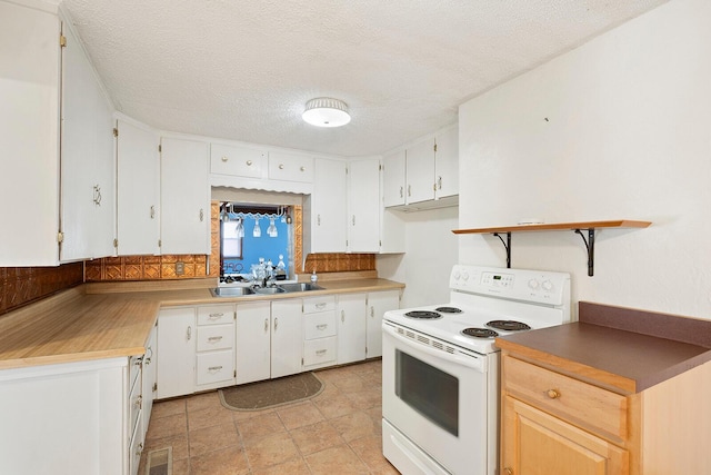 kitchen featuring white cabinets, white electric range, sink, and a textured ceiling