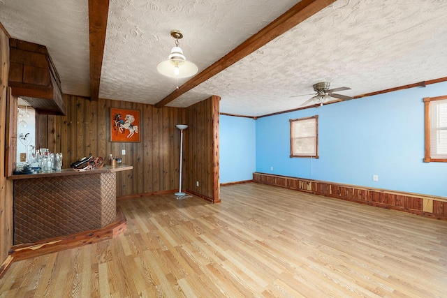 interior space featuring kitchen peninsula, a textured ceiling, light hardwood / wood-style floors, and ceiling fan