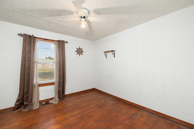 empty room with a textured ceiling, dark hardwood / wood-style flooring, and ceiling fan