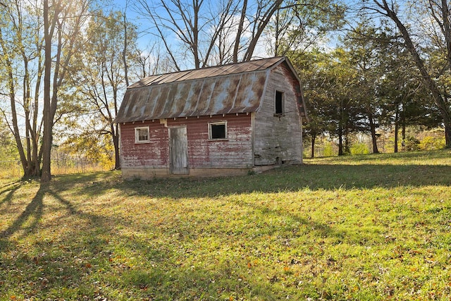 view of outbuilding featuring a lawn