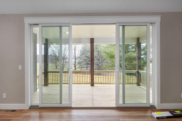 doorway to outside featuring wood-type flooring