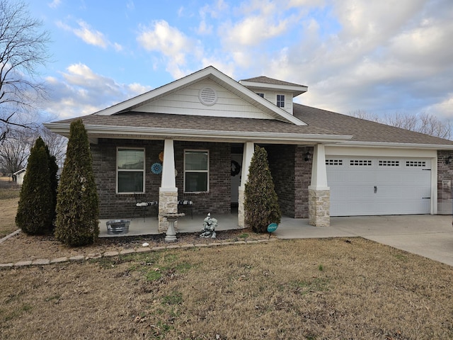 view of front facade with a porch, a garage, and a front yard