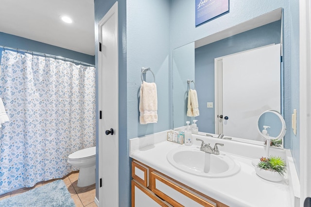 bathroom featuring tile patterned floors, vanity, and toilet