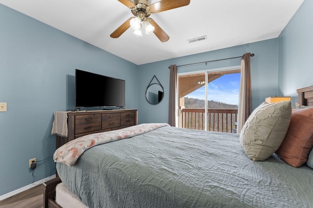 bedroom with access to exterior, hardwood / wood-style floors, and ceiling fan