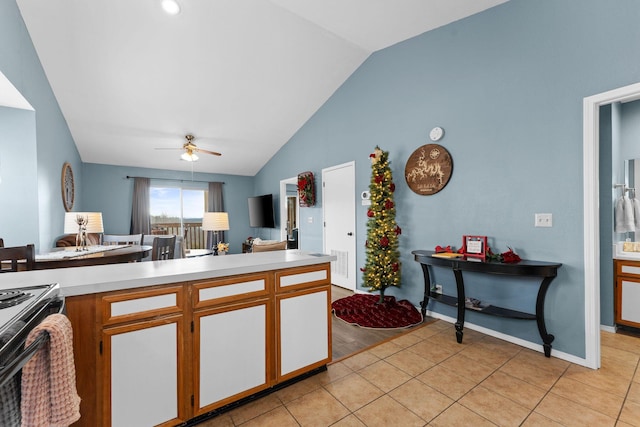 kitchen with light tile patterned floors, ceiling fan, and lofted ceiling