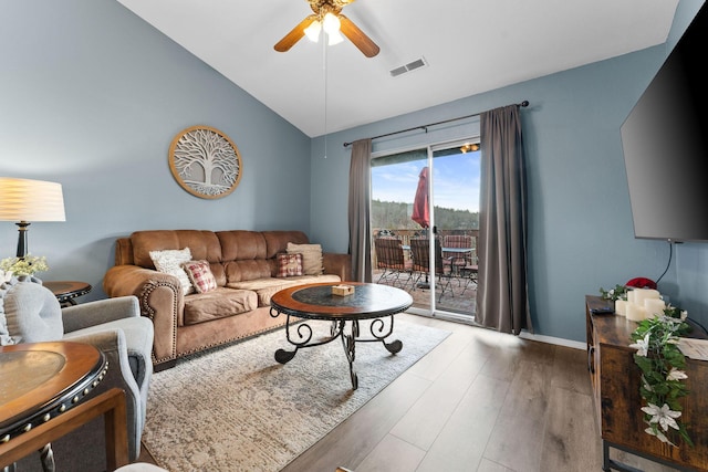 living room featuring hardwood / wood-style flooring, ceiling fan, and lofted ceiling