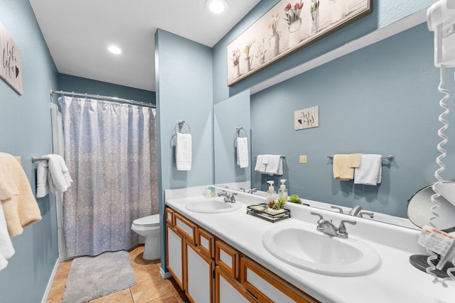 bathroom featuring tile patterned floors, vanity, and toilet