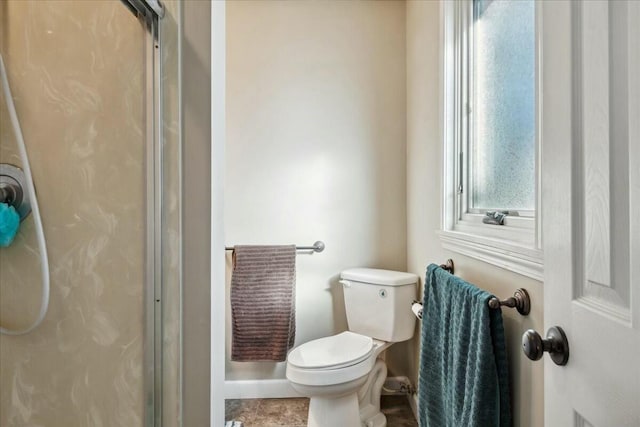 bathroom with toilet, plenty of natural light, and walk in shower