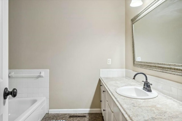 bathroom featuring vanity and a tub