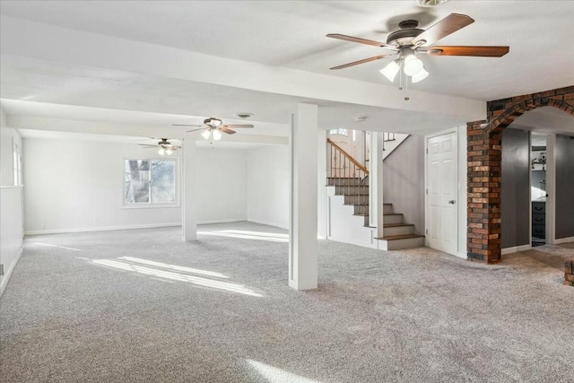 basement featuring carpet flooring and ceiling fan