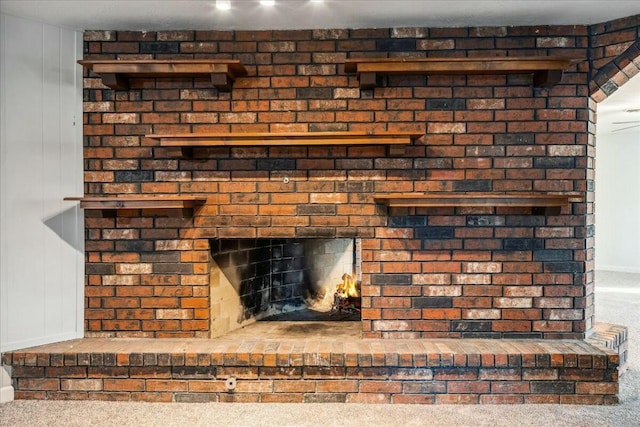 room details featuring a fireplace and carpet floors