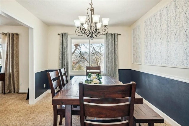 dining area featuring carpet flooring and a notable chandelier