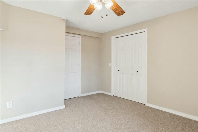 unfurnished bedroom with a closet, light colored carpet, and ceiling fan