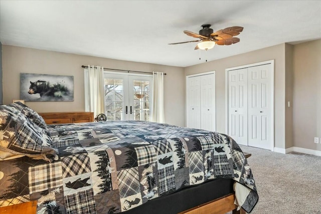 carpeted bedroom featuring french doors, two closets, and ceiling fan