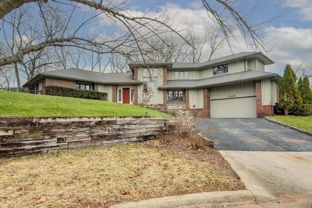 view of front facade featuring a garage and a front lawn